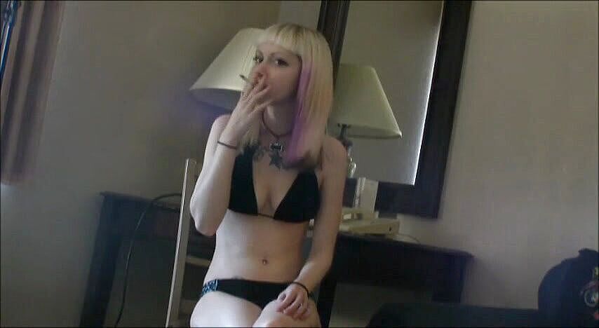 Tattooed teen with colored hair smoking a cigarette--Femdom Austria