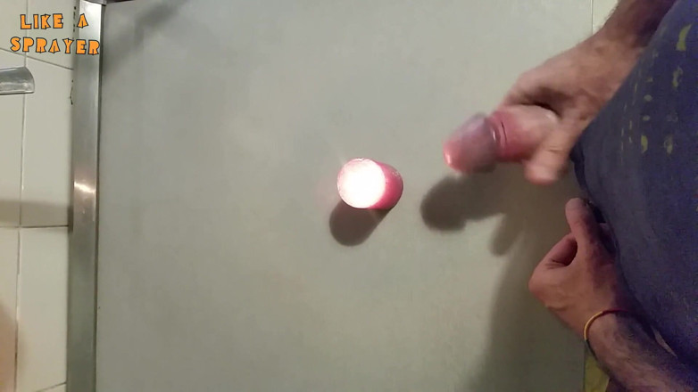 Like a sprayer: Candle cumshot by handjob