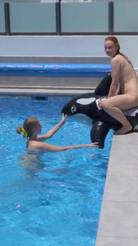 Lesbian Girls Are Having Fun in a Pool with an Inflatable Shark