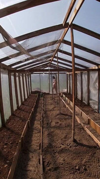 Nude house wife working in the greenhouse