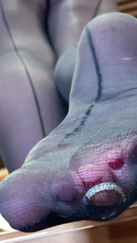 Goddess with Long Legs and Big Ass in Black Pantyhose on the Table Plays with a Toe Ring Above Your Face