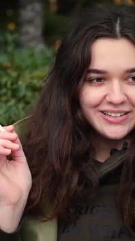 Young Brunette Is Taking an Unhurried Stroll with Allwhite 120mm Cigarette