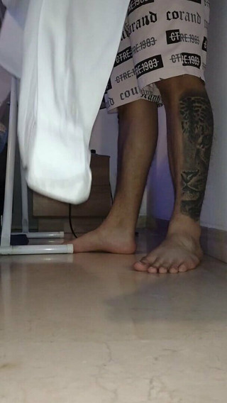 Tomas Styl: Man Shows His Feet While Ironing the Uniform