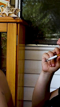 Shaved Head Goth Smokes Outside