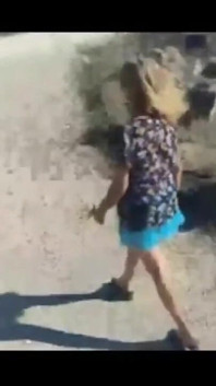 Mel walking on the side of the road