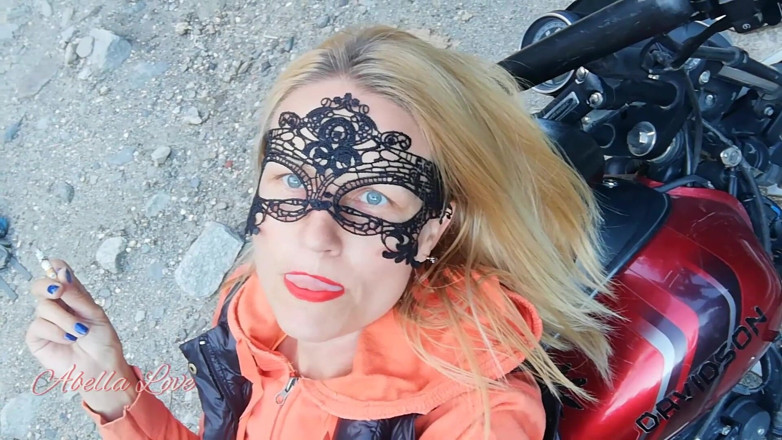 Abella Love: Red lips blonde smoking sensually on Rasta bike outdoor
