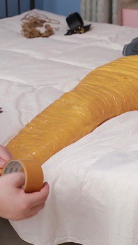A Cute Barefoot Girlfriend Uses Tape to Bind Her Whole Body, Playing with Her Cute Bare Feet