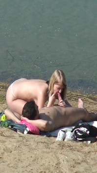 A couple of young nudists are spied on while having sex and enjoying themselves on the beach