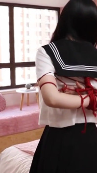 Gg50 - Cute Girl Challenges Herself to Break Free From the Restraints of Ropes and a Single Glove on the Bed.