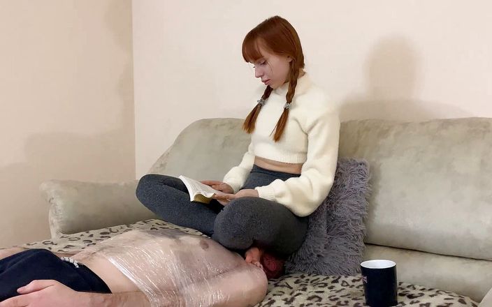 Petite Princesses FemDom: Nerdy girl with pigtails and leggings reading a book while...