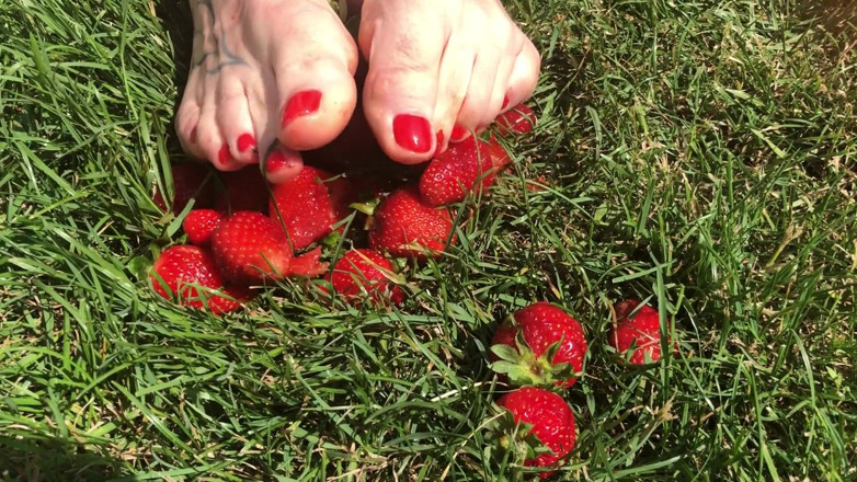 Euro Models: Feet crushing strawberries close up