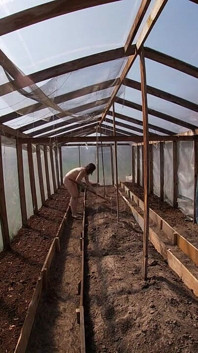 Nude house wife working in the greenhouse