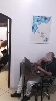 While the Husband Works, the Wife in a Towel Greets the Delivery Man